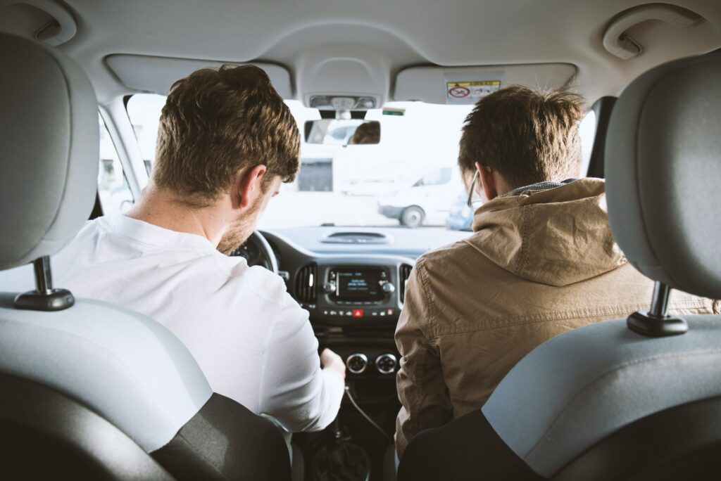 Two men sitting inside a car