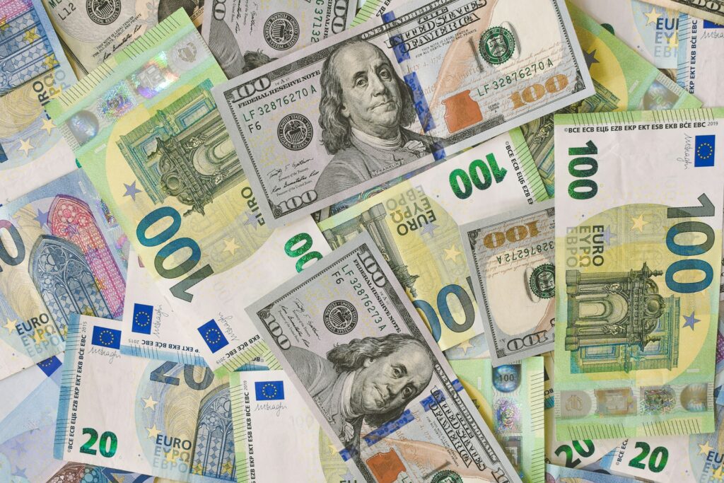 A pile of various currencies including euros and dollars