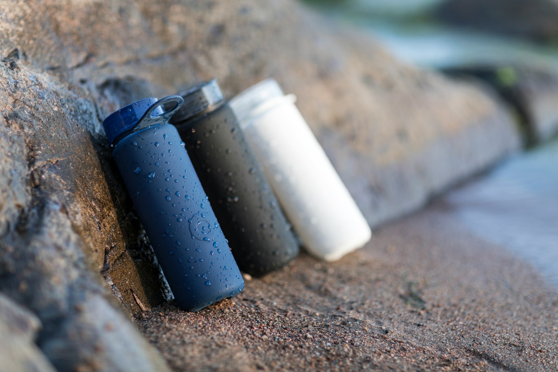 Three water bottles on a rock