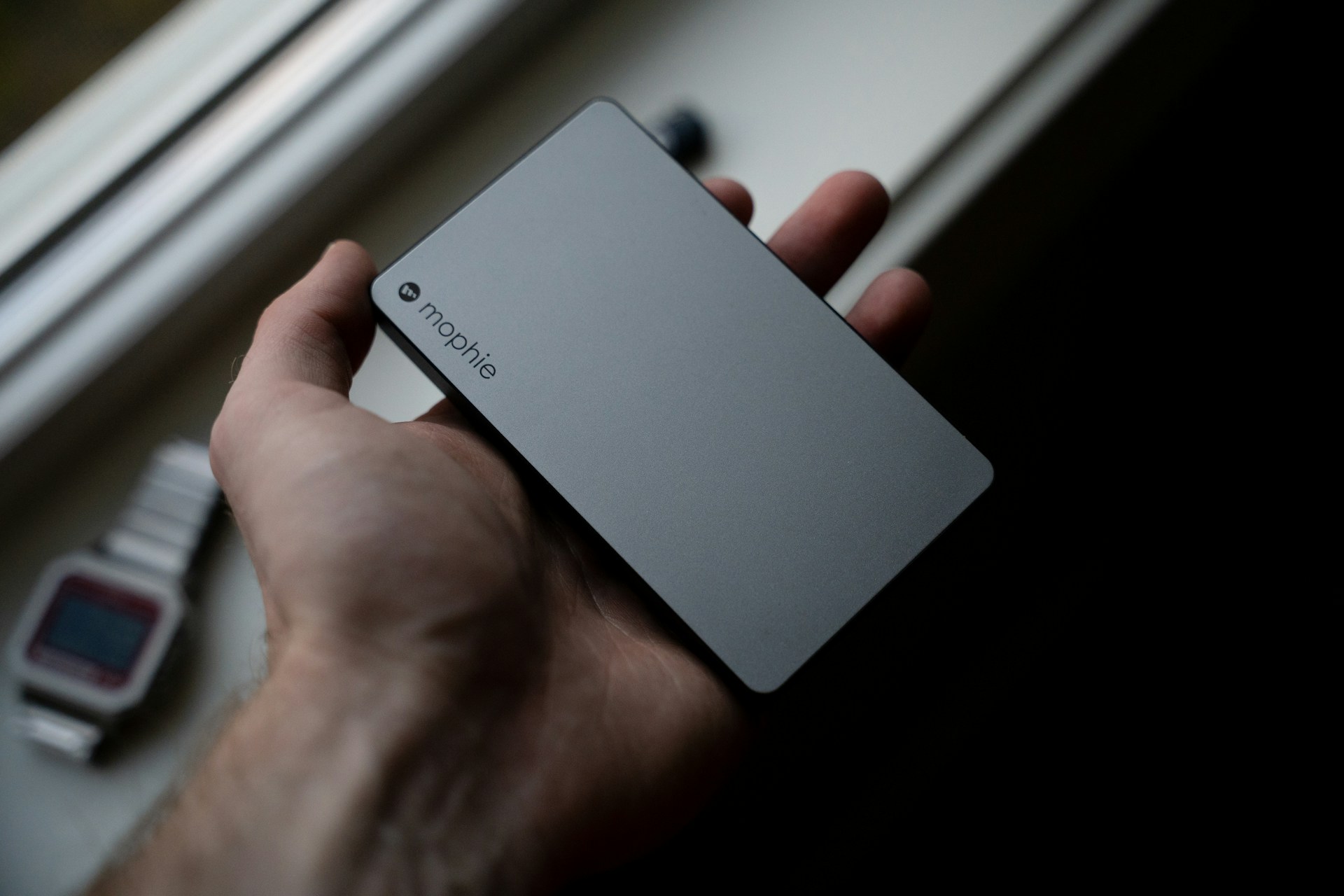 A portable charger in someone's hand