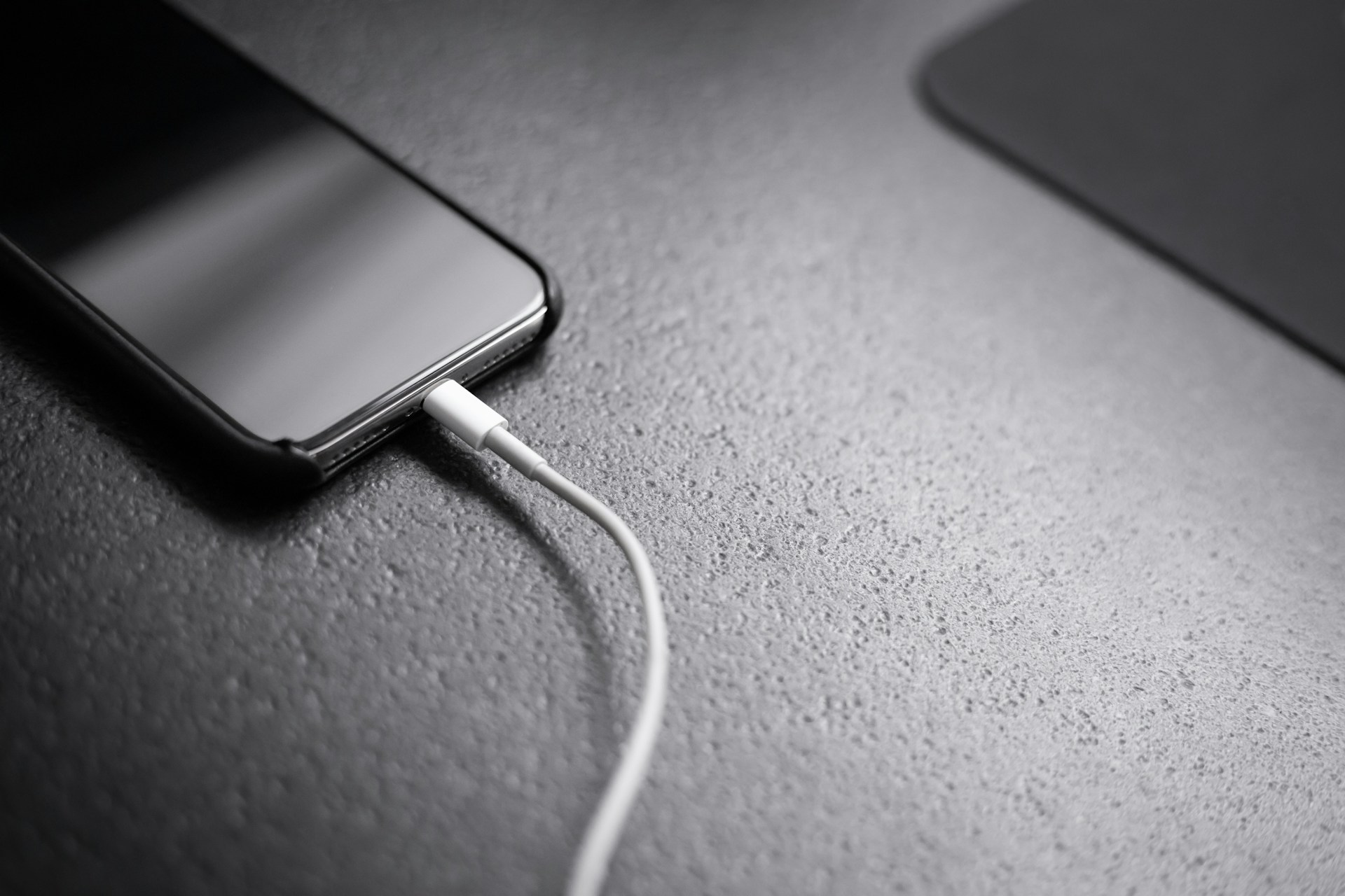 A phone with a charger plugged in