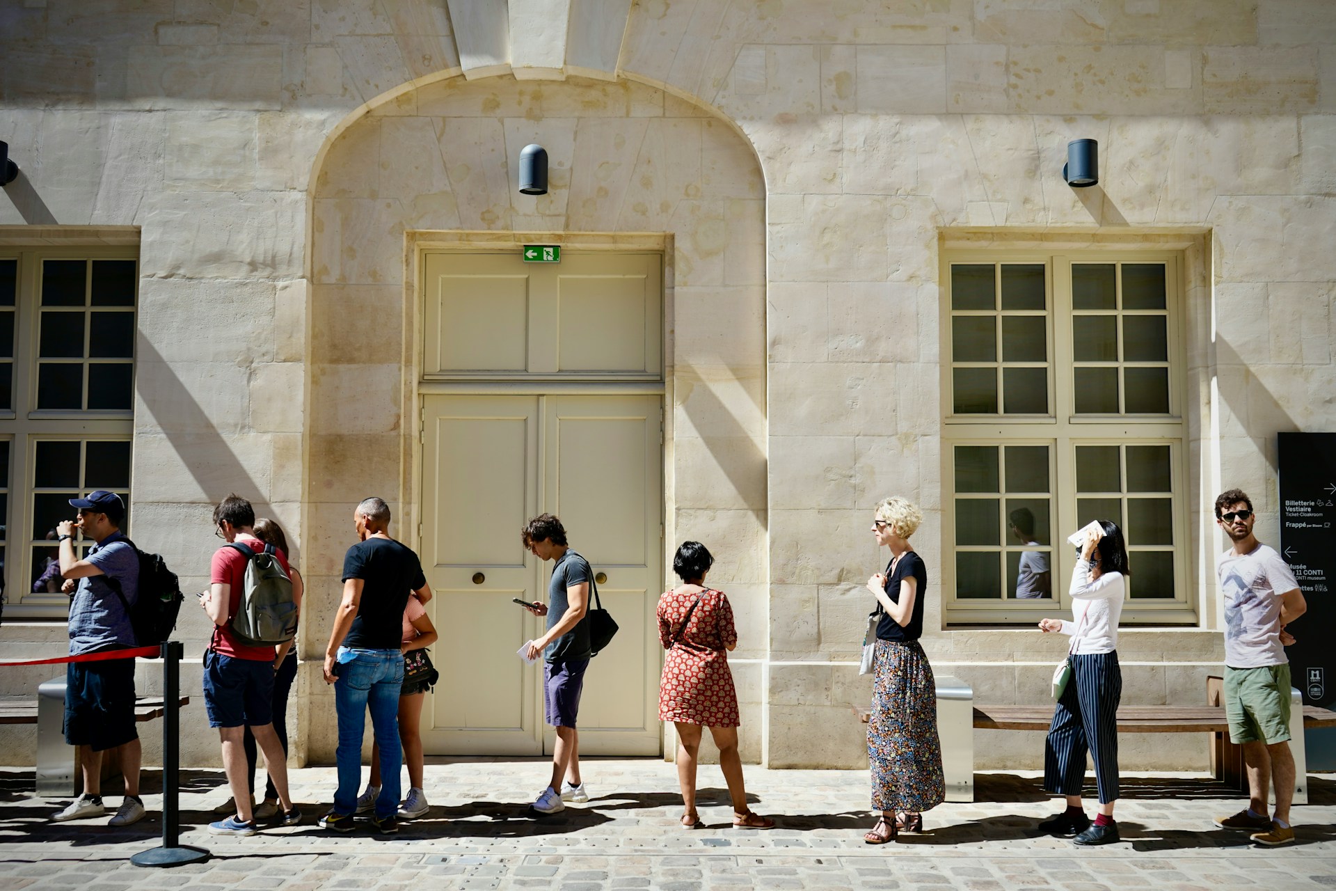 People in a queue outside a building