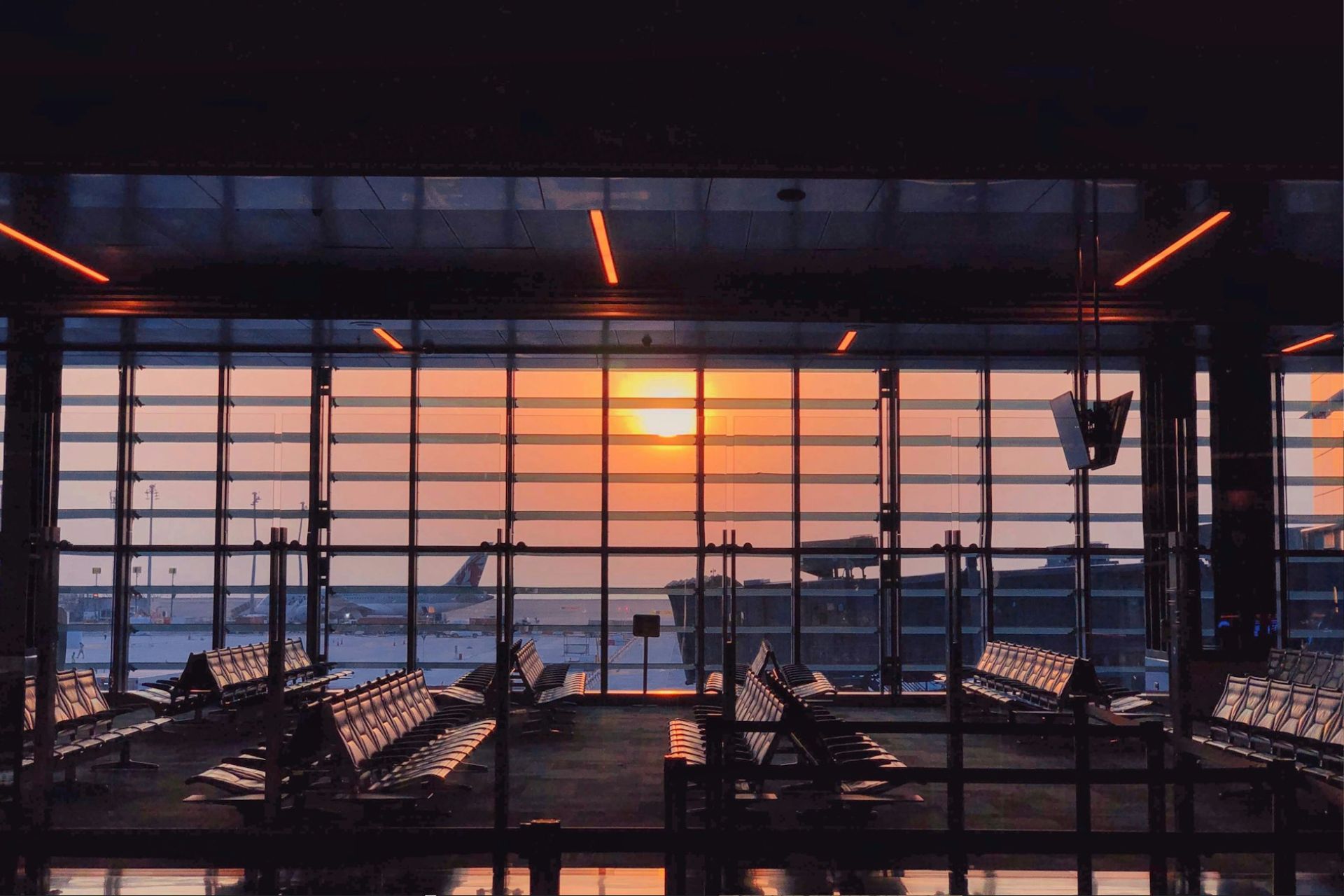 An empty airport gate at sunset
