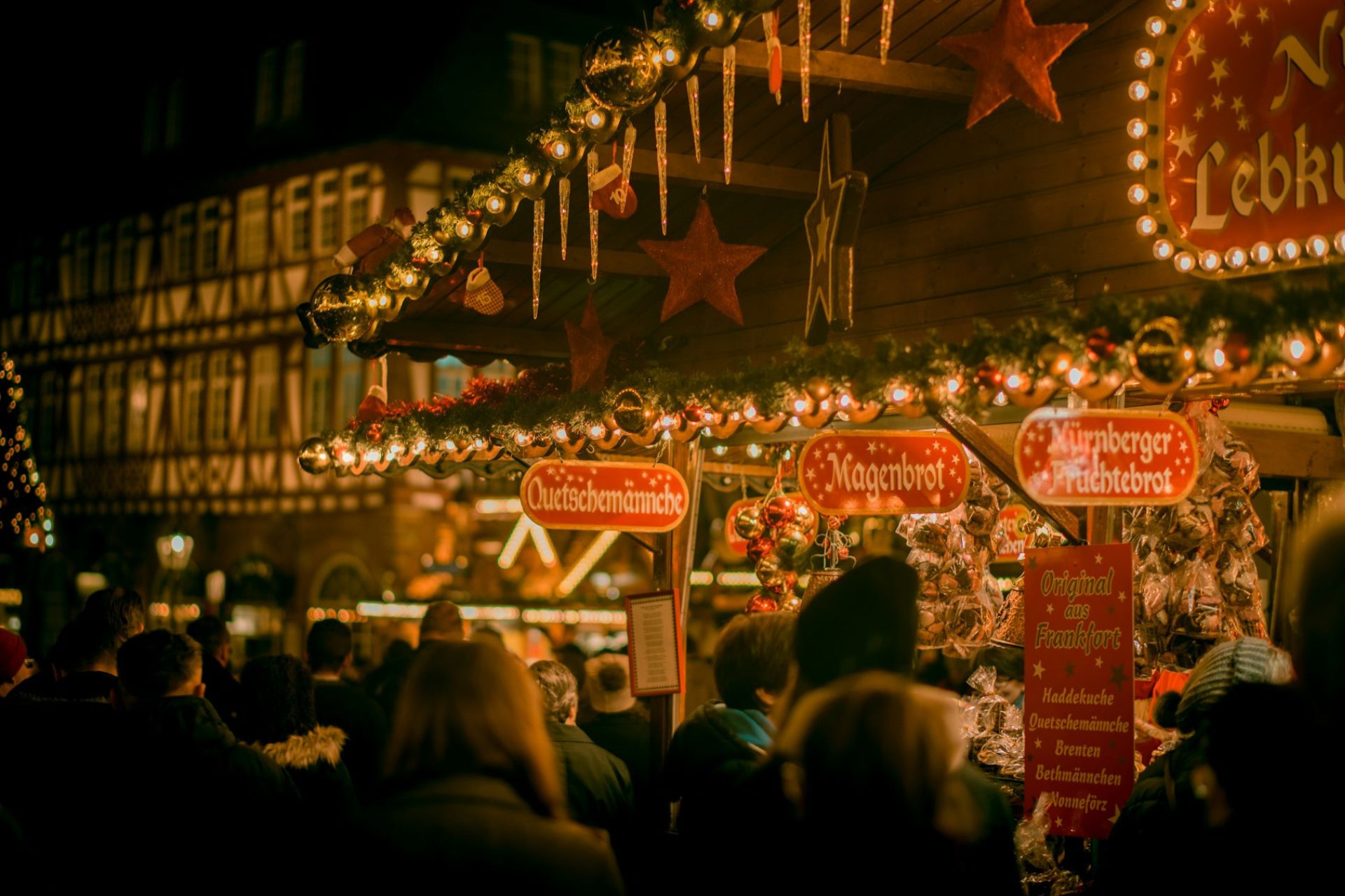 A brightly lit Christmas market stall