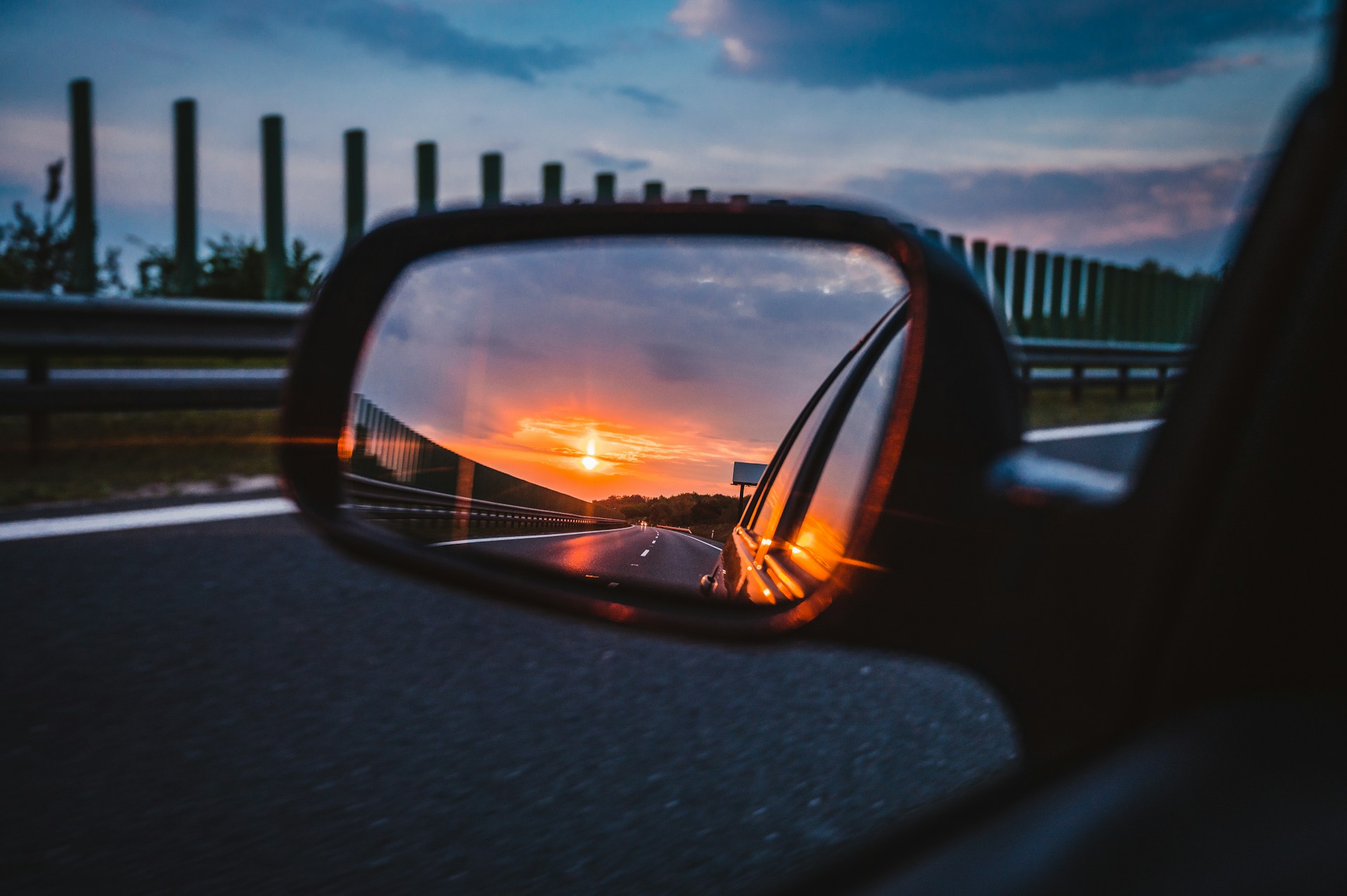 A car wing mirror reflecting sunset