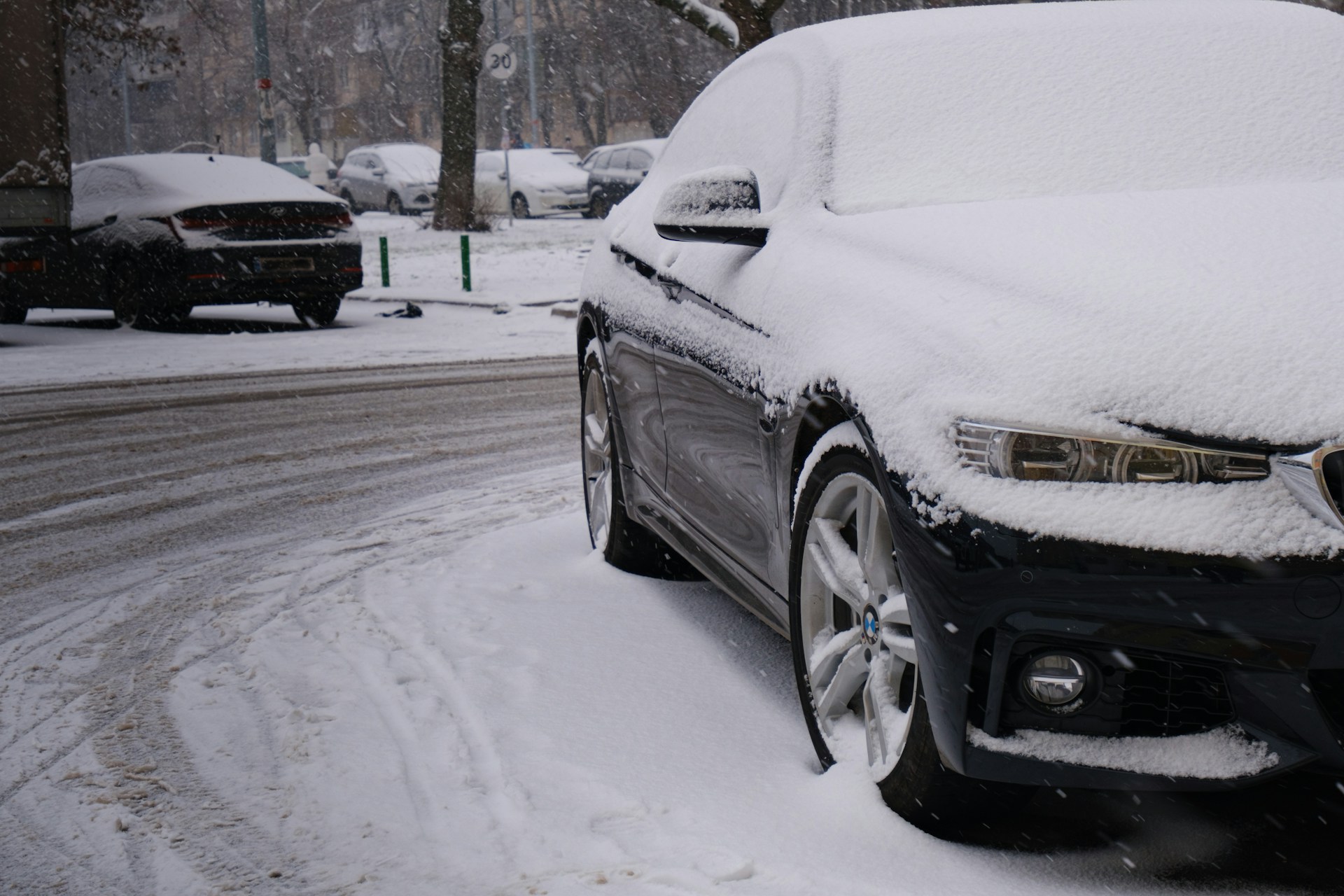 A black car covered in snow
