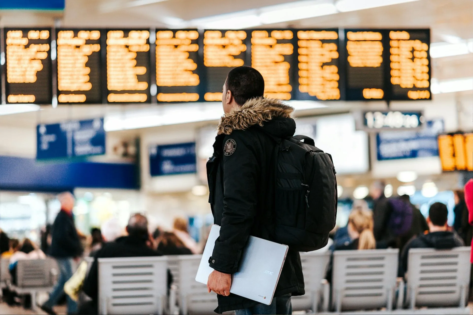 A person looking at an airport departure board