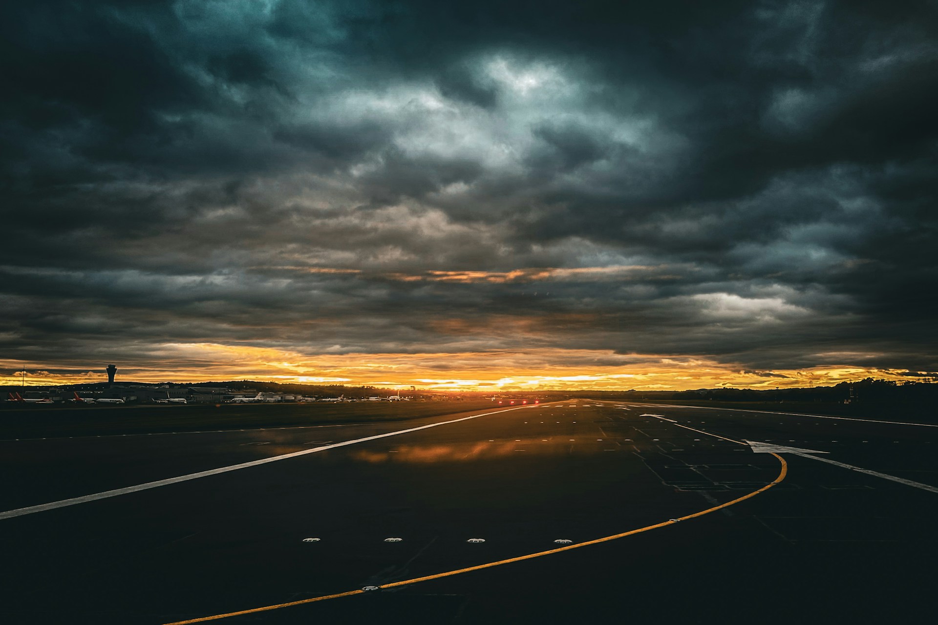 An airport runway at sunset