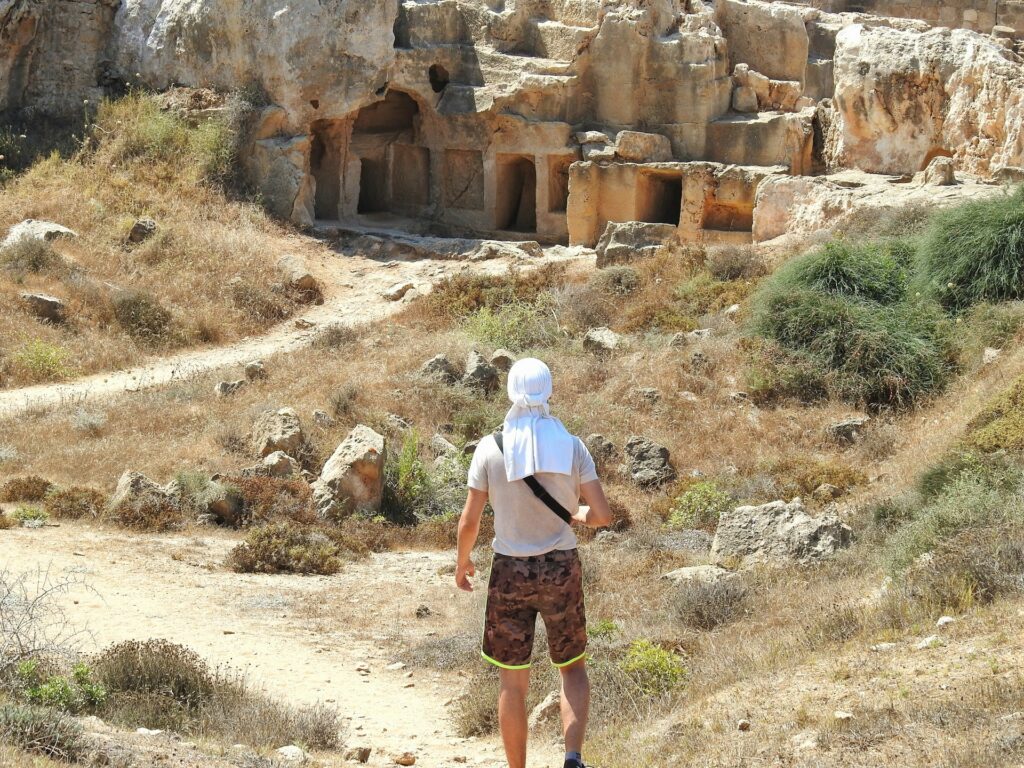 A tourist dressed in white exploring the Kato Paphos park